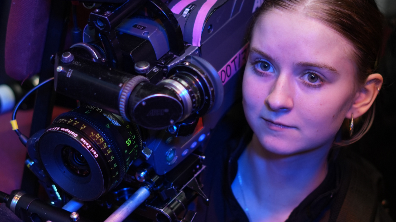 Close up shot of LFA student holding the camera on set